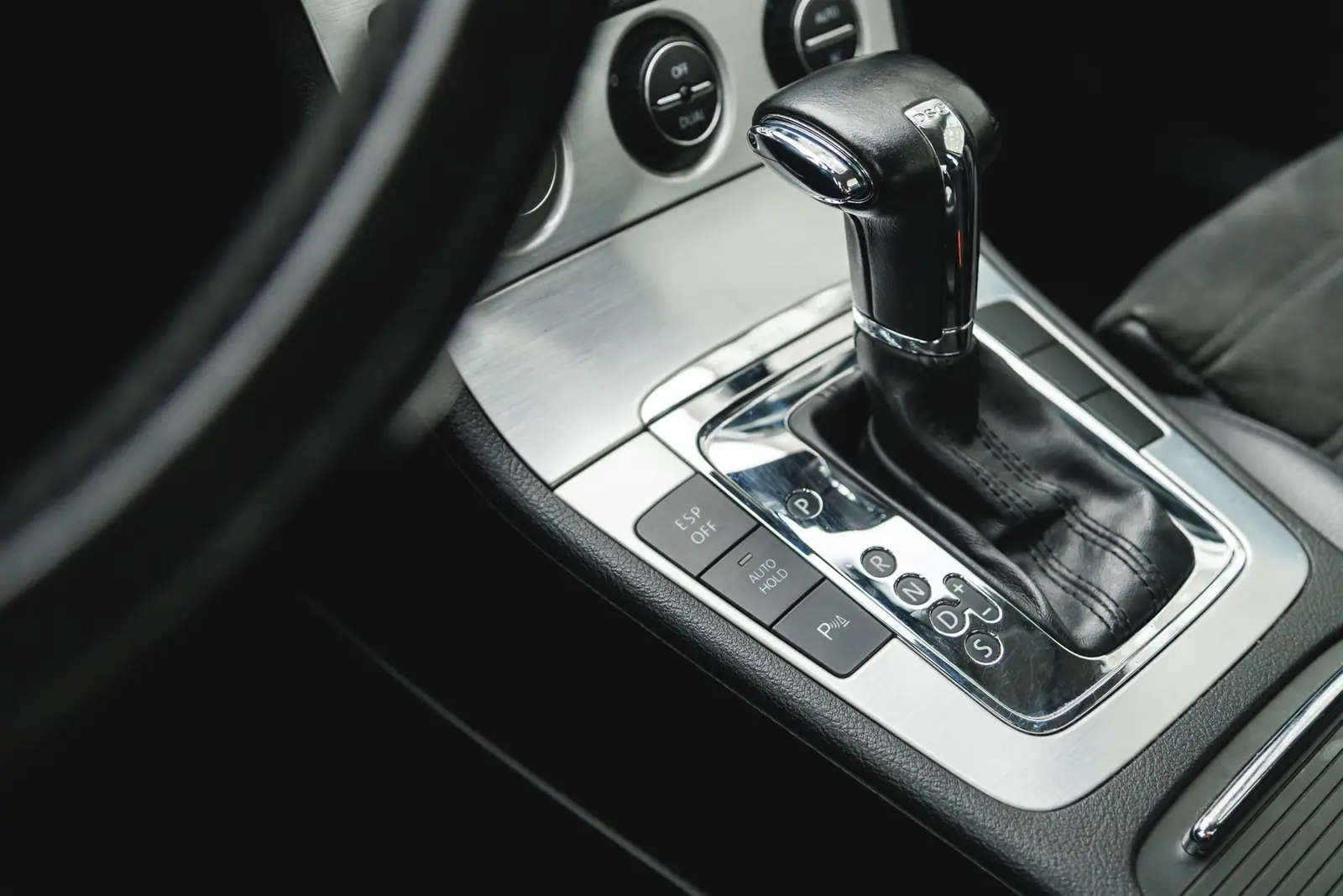 An automatic gear selector and shift-position markings in a car center console
